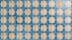 Close-up of Zanzibar Moroccan Arena Blue wall tile featuring a repeating blue and cream Moroccan style eight-point star pattern with a softly weathered finish, perfect for decorative kitchen and bathroom feature walls.