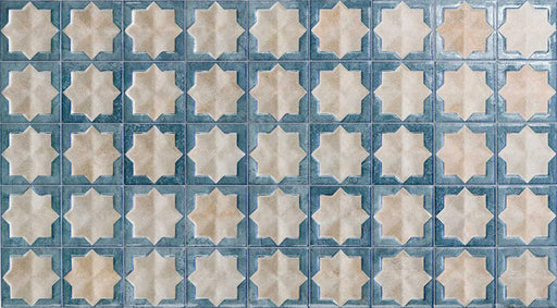 Close-up of Zanzibar Moroccan Arena Blue wall tile featuring a repeating blue and cream Moroccan style eight-point star pattern with a softly weathered finish, perfect for decorative kitchen and bathroom feature walls.