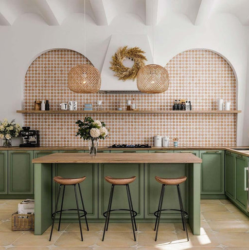 Kitchen featuring Zanzibar Moroccan Cotto White wall tiles in a warm terracotta and white Moroccan style geometric pattern, paired with sage green cabinetry, natural wood worktops, woven pendant lights and Mediterranean-inspired styling.