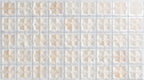Close-up of Zanzibar Moroccan Natural White ceramic wall tiles featuring a repeating Moroccan style geometric star pattern in soft white and warm natural tones, with a glossy glazed finish, subtle shade variation and handcrafted-inspired detailing.