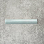 Zellige Aqua 3×20cm Moroccan-style ceramic bullnose tile, showcasing the rounded edge profile, glossy blue-green glaze and subtle tonal variation on a neutral background.