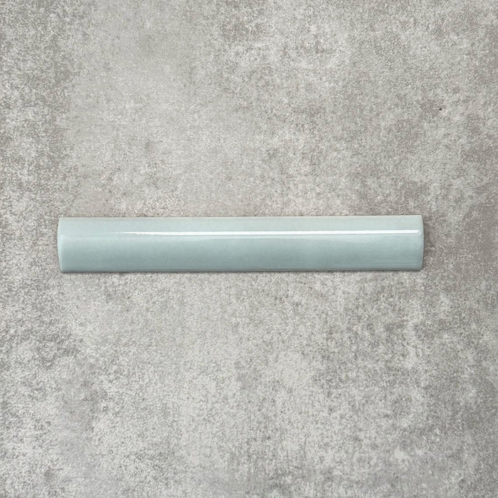 Zellige Aqua 3×20cm Moroccan-style ceramic bullnose tile, showcasing the rounded edge profile, glossy blue-green glaze and subtle tonal variation on a neutral background.
