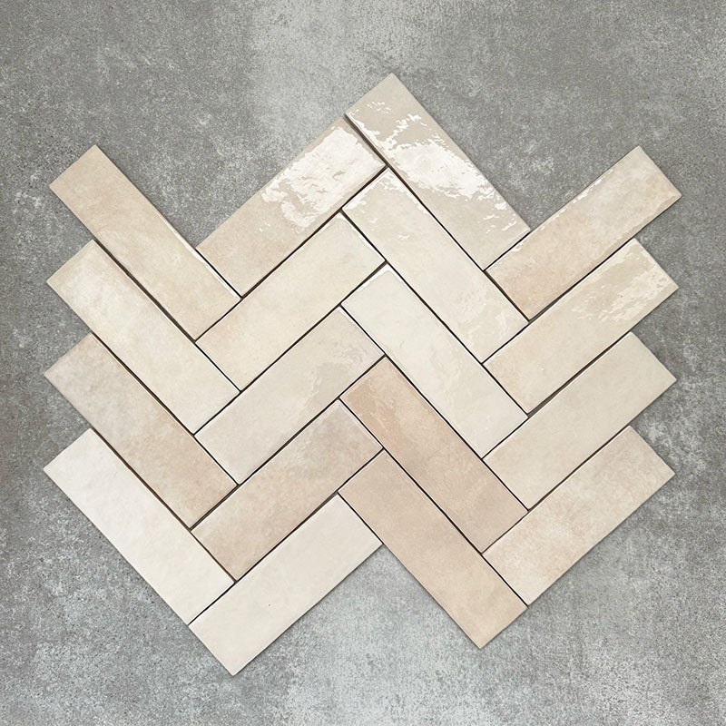 Zellige Bone Moroccan-style brick tiles in a warm beige tone, shown in a simple herringbone layout.