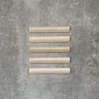 Zellige Bone Moroccan-style bullnose ceramic tiles in a warm beige tone, shown in a neat flat lay arrangement.