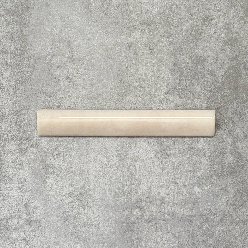 Zellige Bone Moroccan-style bullnose ceramic tile in a warm beige tone, shown in a neat flat lay arrangement.