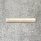 Zellige Bone Moroccan-style bullnose ceramic tile in a warm beige tone, shown in a neat flat lay arrangement.