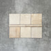 Zellige Bone bullnose ceramic tiles in a soft beige tone, paired with matching square tiles in a flat lay layout.