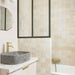 Bathroom featuring Zellige Bone Moroccan-style square tiles in soft neutral tones, paired with brass fittings and a stone basin.