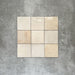 Zellige Bone square tiles laid in a simple grid, featuring a glossy white finish with subtle tonal variation and softly uneven edges.