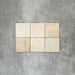 Zellige Bone square tiles laid in a simple grid, featuring a glossy white finish with subtle tonal variation and softly uneven edges.