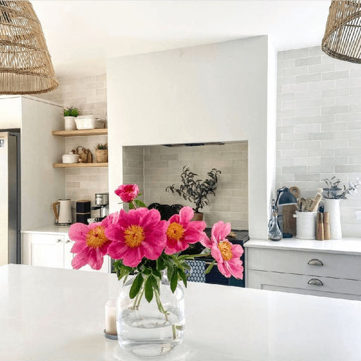 Zellige Chalk White Moroccan-style brick tiles used as a kitchen splashback, creating a soft, handcrafted finish behind open shelving and worktops.