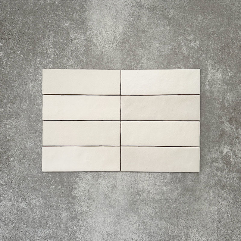 Zellige Chalk White Moroccan-style brick tiles in a 6.5 × 20cm format, showing a soft chalky white glaze with subtle handmade surface variation.