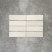 Zellige Chalk White Moroccan-style brick tiles in a 6.5 × 20cm format, showing a soft chalky white glaze with subtle handmade surface variation.