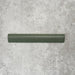 Zellige Malachite Green 3×20cm Moroccan-style ceramic bullnose tile, showcasing the rounded edge profile, rich green glaze and subtle tonal variation on a neutral background.