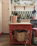 Kitchen interior featuring Zellige Malachite Green and Zellige Oyster 6.5x20cm Moroccan-style brick tiles installed vertically in a striped splashback, styled with brass tap, wooden shelving, and greenery for a warm, contemporary look.