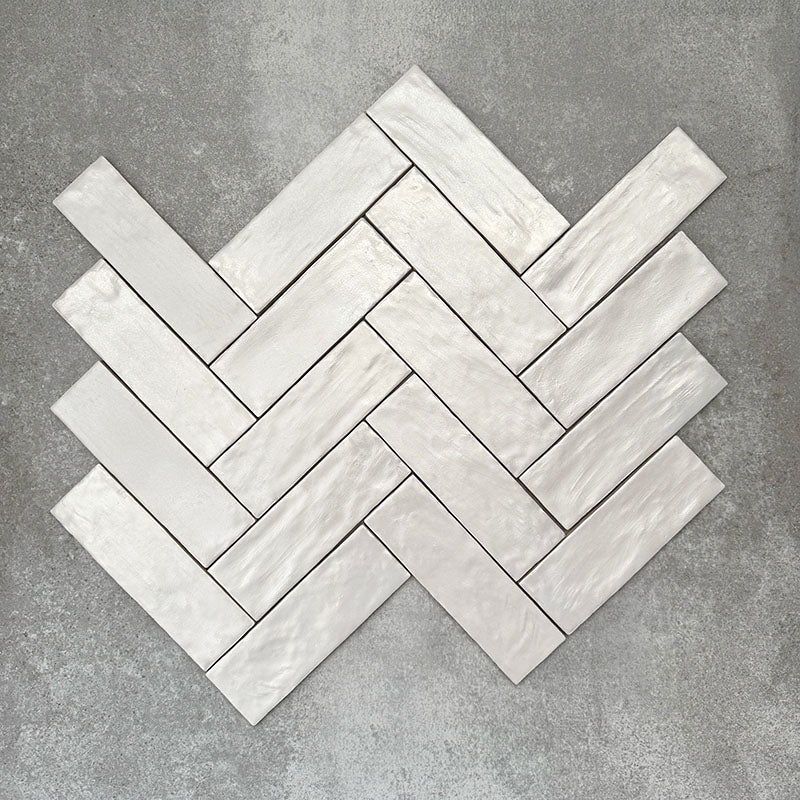 Herringbone layout showcasing Zellige Oyster Brick Moroccan-style ceramic tiles in a 6.5 × 20cm format, with the angled pattern emphasising the handcrafted edges, glossy oyster glaze and natural tonal variation for a timeless, artisanal finish.