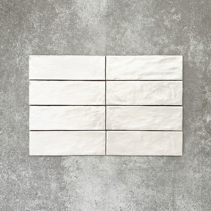 Vertical brick layout featuring Zellige Oyster Brick Moroccan-style ceramic tiles in a 6.5 × 20cm format, highlighting the handmade texture, softly rippled surface and subtle tonal variation of the glossy oyster glaze for a clean yet characterful finish.