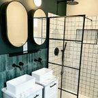 Bathroom featuring Zellige Oyster Square Moroccan-style ceramic tiles in a 10 × 10cm format, installed in a clean grid layout across the shower walls, with a glossy oyster-white glaze, softly uneven surfaces and subtle tonal variation adding handcrafted texture alongside black-framed shower screens and contemporary fixtures.