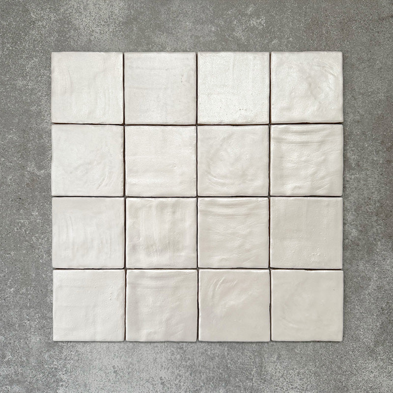 Zellige Oyster Square Moroccan-style ceramic tiles in a 10 × 10cm format, shown in a grouped layout highlighting the soft oyster-white glaze and subtle handmade surface variation.