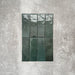 Flat lay of Zellige Royal Green Brick 6.5 × 20cm Moroccan-style ceramic tiles in rich deep green tones, arranged in a vertical brick layout on a textured grey background, showcasing the glossy glaze, natural tonal variation and handcrafted zellige-effect finish.