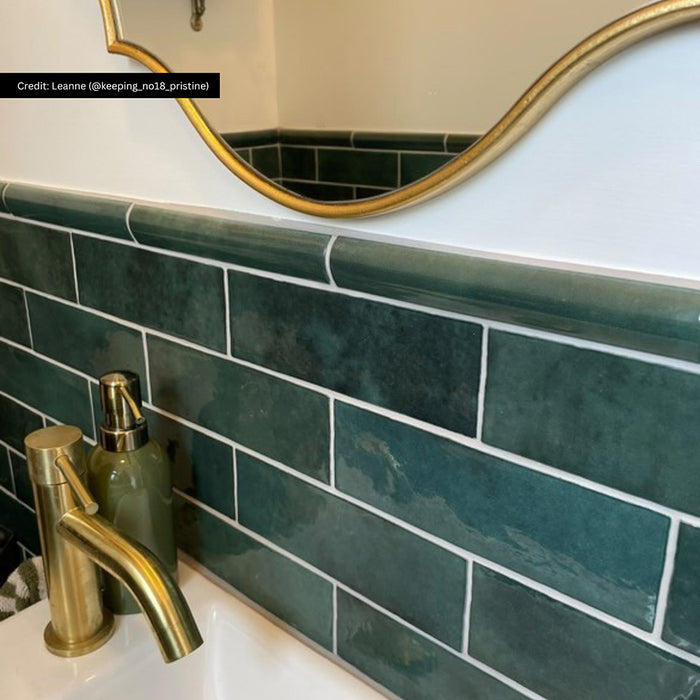Bathroom splashback featuring Zellige Royal Green Brick 6.5 × 20cm Moroccan-style ceramic wall tiles finished with a matching Royal Green Bullnose 3 × 20cm trim, showcasing rich deep green tones, a glossy glaze and softly rounded edging paired with brass fittings for a refined zellige-effect finish.