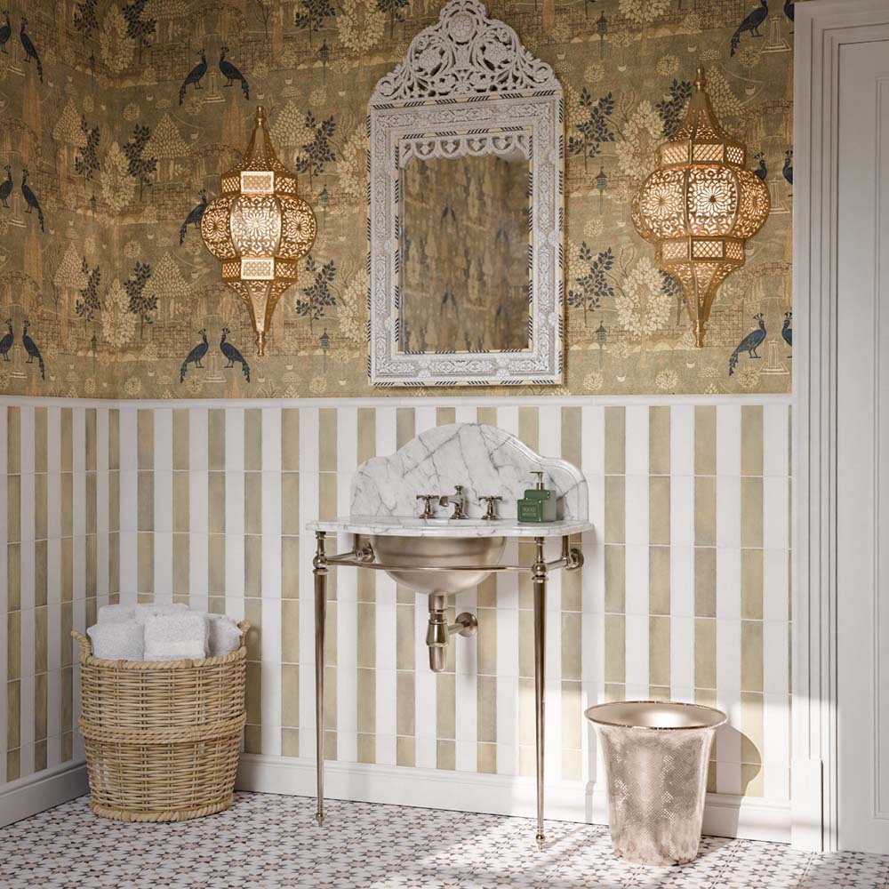 Bathroom featuring Zellige Weald Green Brick 6.5x20cm Moroccan-style wall tiles, arranged vertically in a striped design with white tiles, paired with patterned floor tiles, decorative wallpaper and a marble washbasin.