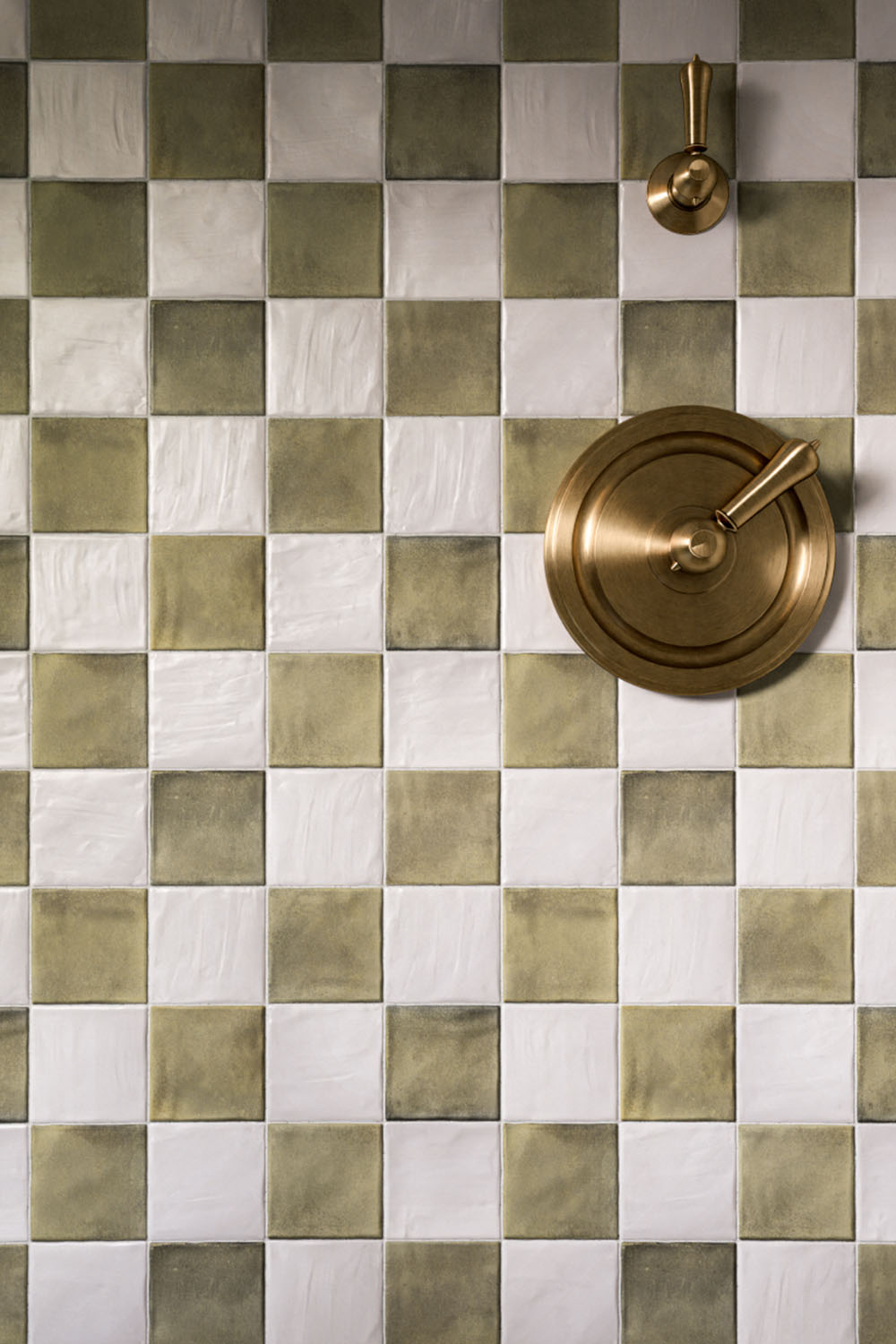 Zellige Weald Green Square 10cm x 10cm Moroccan style tiles, paired with crisp white squares in a classic chequerboard layout, highlighting the softly varied green tones and glossy finish.