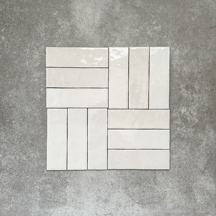 Zellige White brick tiles arranged in a basketweave pattern, featuring a glossy white finish with natural tonal variation.