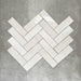 Zellige White brick tiles arranged in a herringbone pattern, featuring a glossy white finish with natural tonal variation.