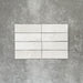 Zellige White brick tiles in a 6.5 × 20cm format, shown in a clean white gloss with subtle surface variation.