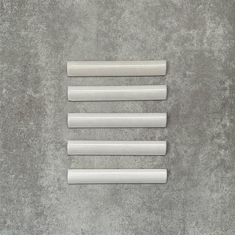 Zellige White bullnose Moroccan-style ceramic tiles in a 3 × 20cm format, shown in a neat row with a smooth, glossy finish.