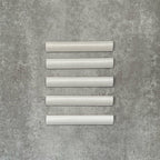 Zellige White bullnose Moroccan-style ceramic tiles in a 3 × 20cm format, shown in a neat row with a smooth, glossy finish.
