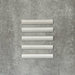 Zellige White bullnose Moroccan-style ceramic tiles in a 3 × 20cm format, shown in a neat row with a smooth, glossy finish.