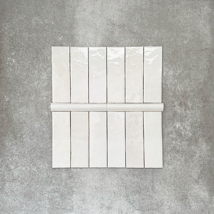 Zellige White Moroccan-style ceramic brick tiles with matching 3 × 20cm bullnose trim, shown in a clean, glossy white finish.
