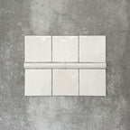 Zellige White Moroccan-style ceramic square tiles with matching 3 × 20cm bullnose trim, shown in a clean, glossy white finish.