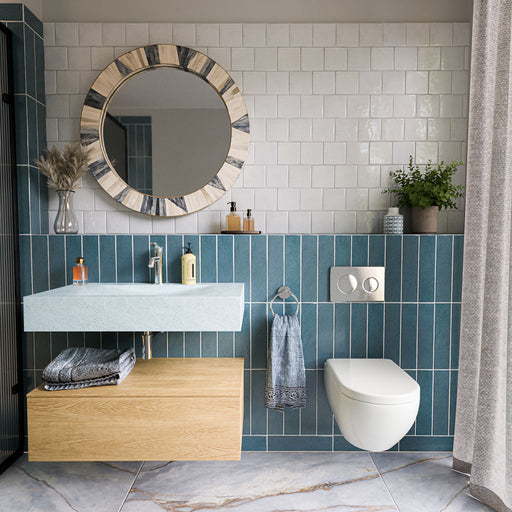 Bathroom featuring Zellige White Square 13.2cm x 13.2cm Moroccan-style wall tiles, paired with blue vertical tiles, marble effect flooring, a wooden vanity and a round statement mirror.