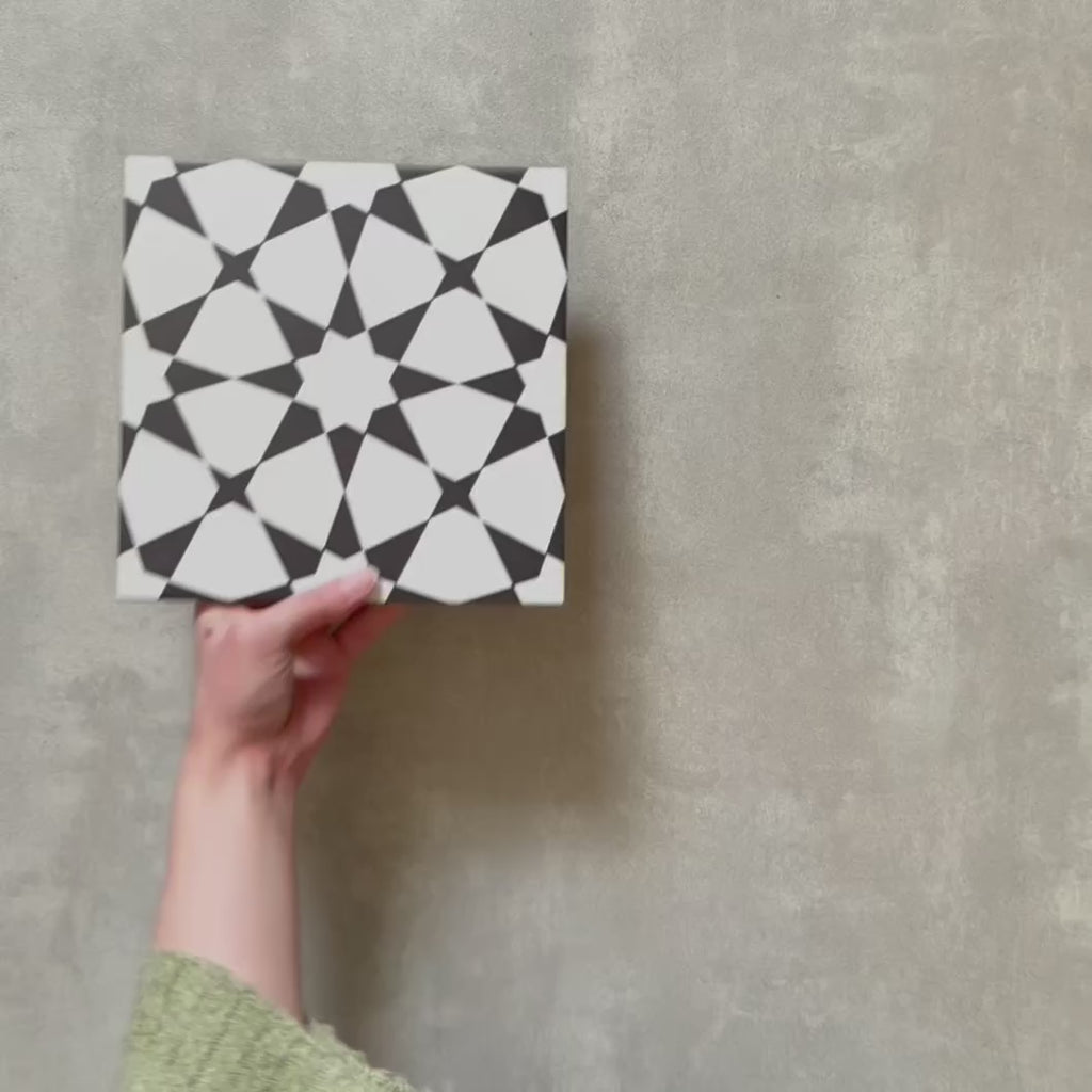 Video showcasing Agadir Black & White Moroccan-style 20x20cm porcelain tiles, highlighting the bold geometric star pattern and crisp black and white contrast.