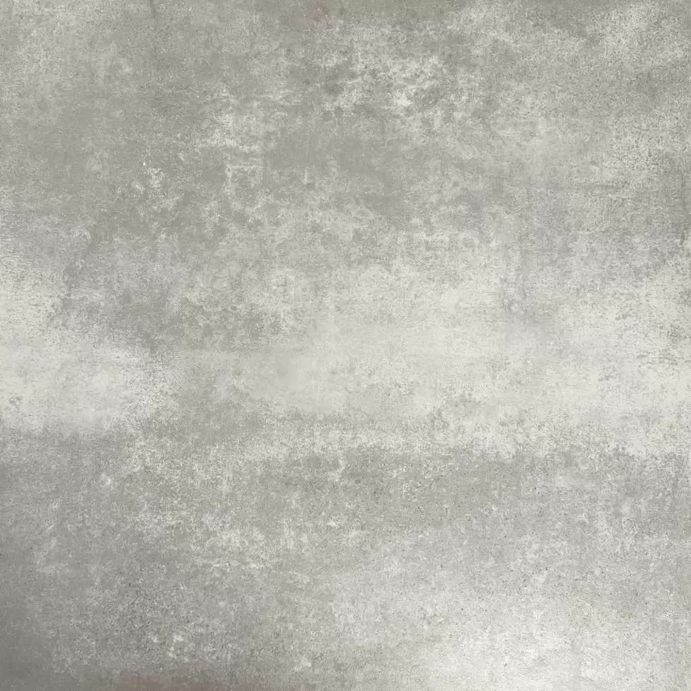 Video showcasing Fez Springs 20x20cm Moroccan-style porcelain tiles arranged as a four-tile panel, highlighting the full repeat design with layered blue and soft green geometric star motifs against a textured grey background.