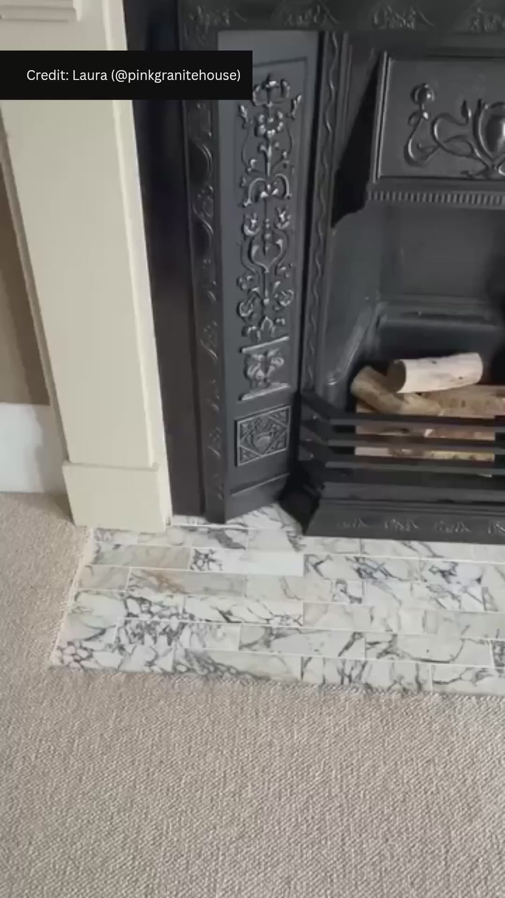 Fireplace hearth featuring Fayrouz Picasso Honed Finish Natural Marble 5cm x 20cm tiles, showcasing striking grey veining on a white marble background, paired with a traditional cast iron fireplace and neutral carpet.