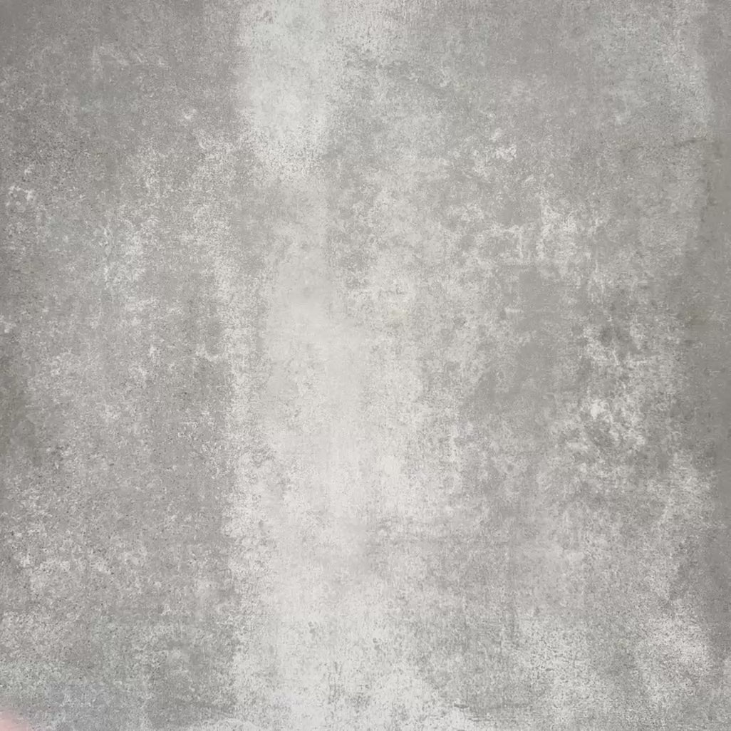 Video showcasing Zellige Rose Pink Brick 6.5 × 20cm Moroccan-style ceramic tiles, shown in soft blush, dusty rose and terracotta pink tones with gentle tonal variation and lightly uneven edges, being arranged in a herringbone brick layout on a textured grey background to showcase the handcrafted zellige-effect glaze.