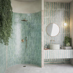 Bathroom setting featuring Jumairah Almond Nut and Jumairah Aqua Green 5x40cm gloss wall tiles, installed in a vertical layout, showcasing warm neutral and soft green tones, paired with contemporary fittings and a clean, modern interior.