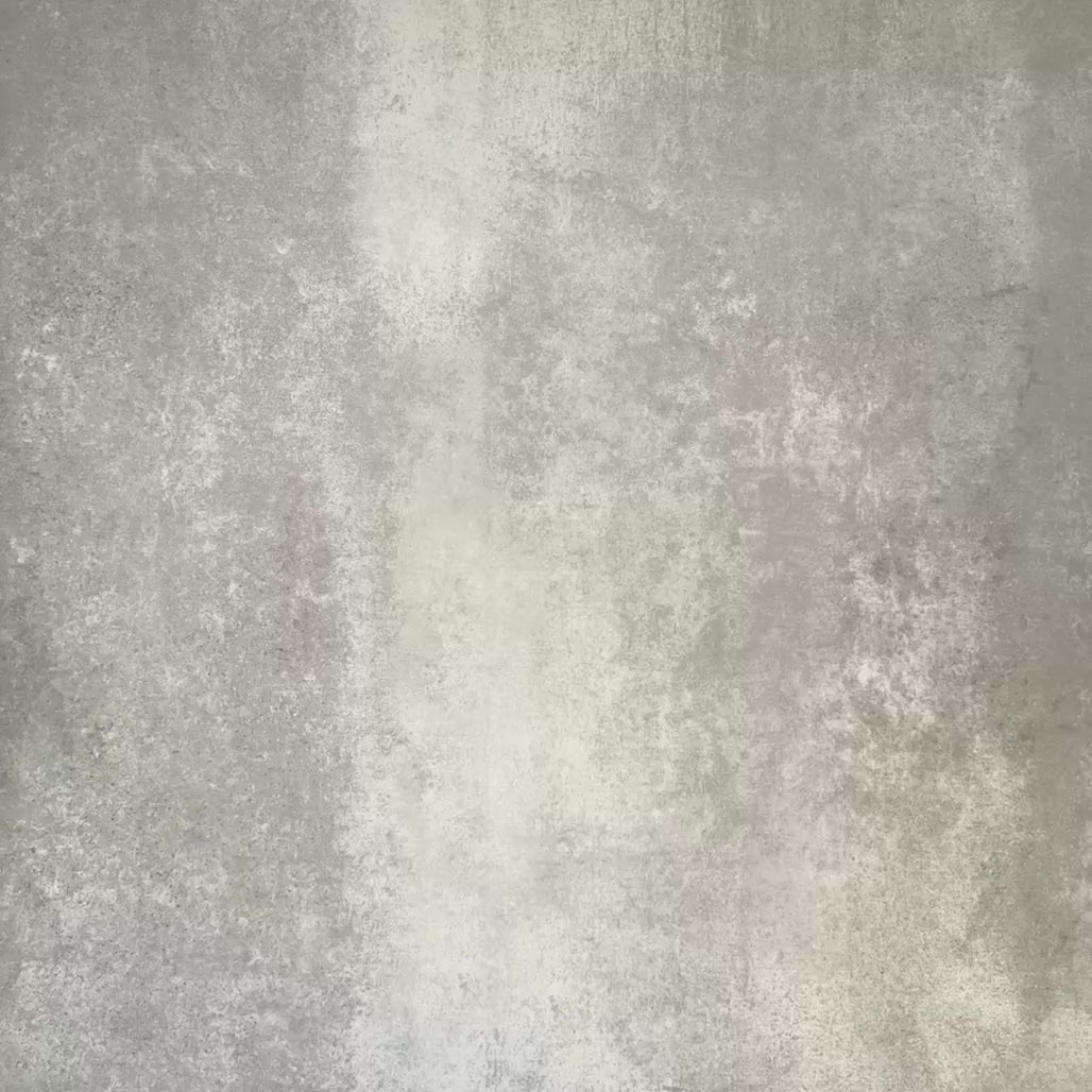 Video showcasing Flat lay of Zellige Arena Marfil Brick 6.5 × 20cm Moroccan-style ceramic tiles, shown in a warm beige and cream colour palette with subtle tonal variation and gently uneven edges, being arranged in a herringbone layout on a textured grey background to highlight the handcrafted, zellige-effect finish.