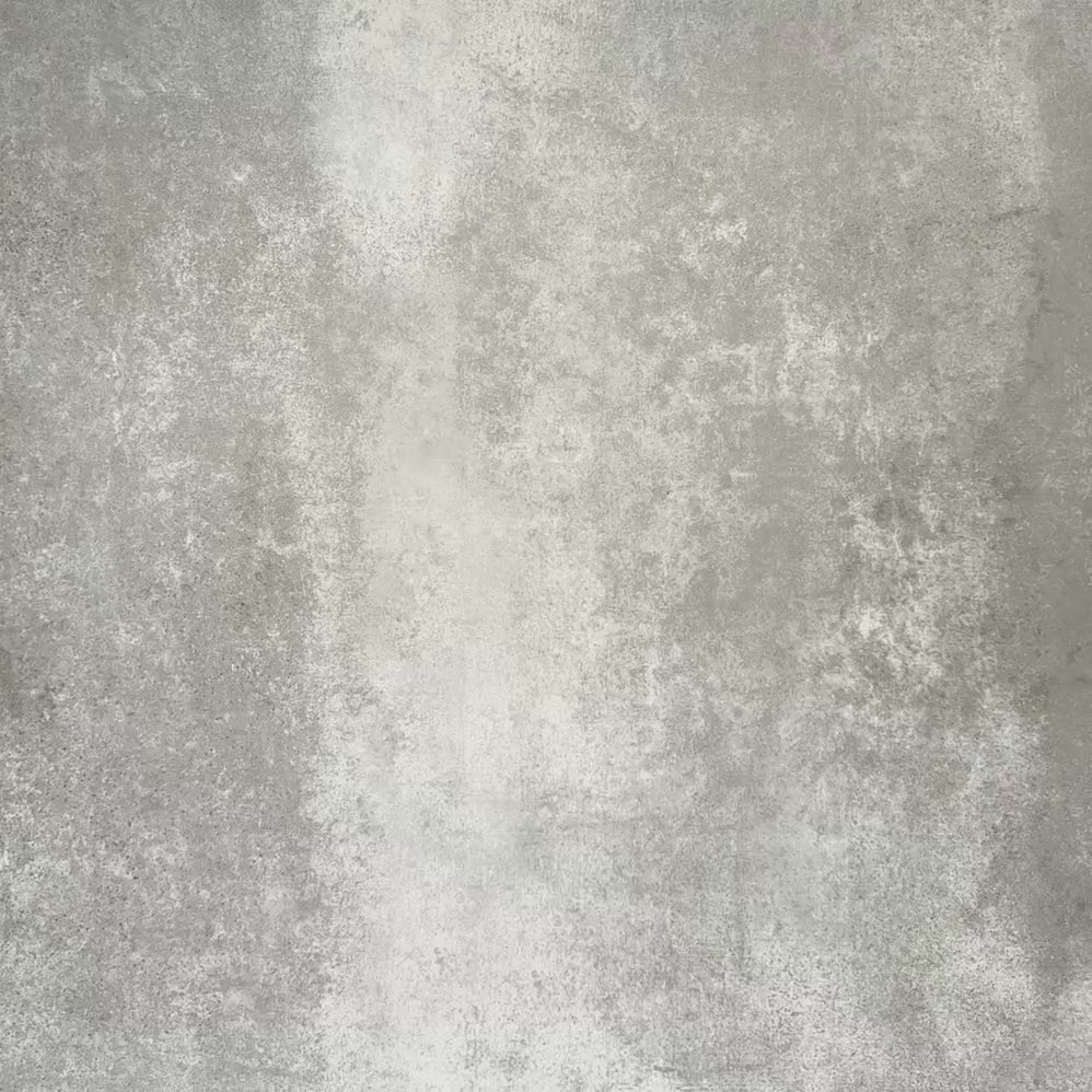 Video showcasing Zellige Pink Mist Brick 6.5 × 20cm Moroccan-style ceramic tiles in soft pale pink and blush tones, arranged in a herringbone layout on a textured grey background, showcasing the glossy glaze, gentle tonal variation and handcrafted zellige-effect finish.