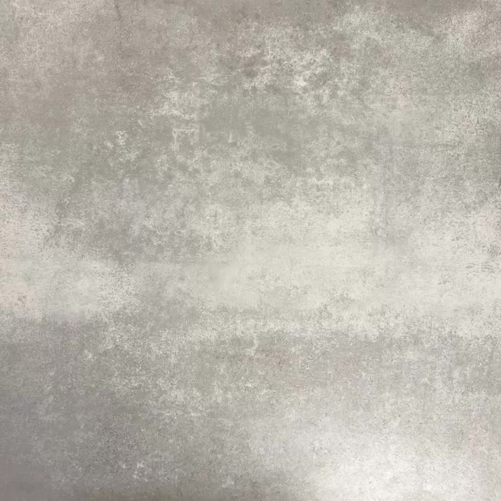 Video showcasing Fez Mini Springs 15x15cm Moroccan-style porcelain tiles arranged as a four-tile panel, highlighting the full repeat design with layered blue and soft green geometric star motifs against a textured grey background.