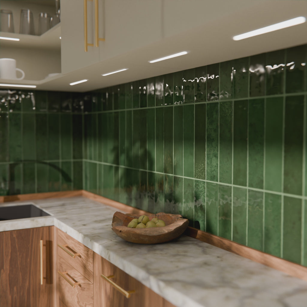 Video showing Nairobi gloss moss green handmade-effect tiles, with light moving across the textured glazed surface to highlight the rich colour depth and natural tonal variation.