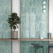 Jumairah Aqua Green slim wall tiles installed vertically in a café interior, showcasing a muted aqua glaze with tonal depth and subtle surface texture.