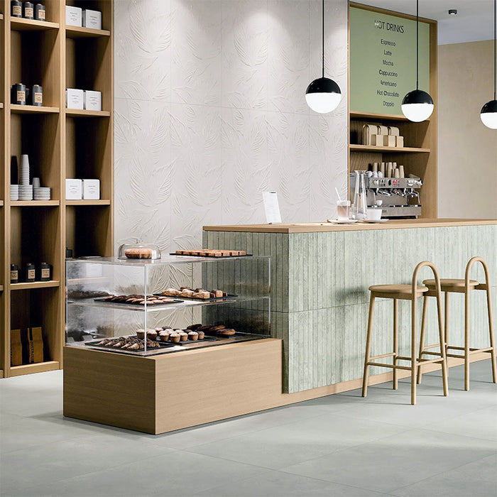 Jumairah Green 5x40 wall tiles used on a café counter, showing subtle texture and muted green tones in a commercial interior